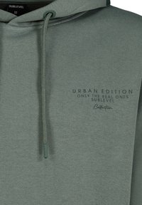 Green hoodie made of soft fabric featuring a drawstring hood, front print with "Urban Edition" and "Sublevel" text, and ribbed cuffs.
