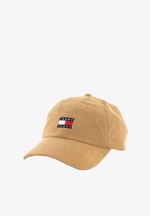 Brown corduroy baseball cap with a curved visor and an embroidered logo patch displaying "TOMMY JEANS" in blue, white, and red.