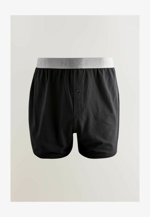 Čierne bavlnené boxerské šortky so šedým elastickým pásom, na ktorom je vytlačené v subtilnej textúre slovo "NEXT". Obsahujú detail s predným gombíkom.