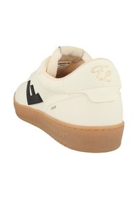 White sneaker with black accent logo, made of smooth synthetic material, features a textured gum sole, soft collar, and subtle brand detailing.