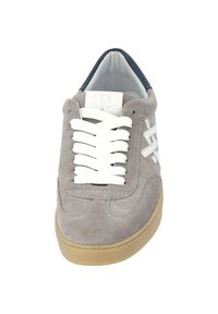 Gray suede sneaker with white laces and a textured rubber sole. Features a navy interior and decorative stitching on the upper.