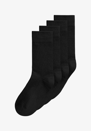Vier Paar schwarze gerippte Crew-Socken gestapelt, wobei ein Paar leicht vor den anderen auf weißem Hintergrund liegt.