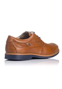 Chaussure en cuir marron avec une surface lisse, un bout arrondi et des détails perforés. Elle possède une semelle contrastante bleu marine et des lacets bleus.