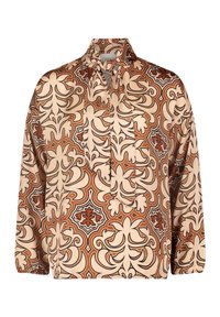 Blus med långa ärmar i en beige tyg med ett stort brunt och orange blommönster, krage med knytning vid halsen och elastiska ärmslut.