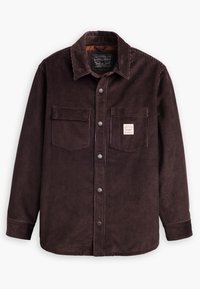 Brown corduroy shirt with a button-up front, two chest pockets, and a label. Features a collar and ribbed texture throughout.