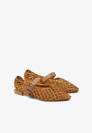 Brązowe płaskie buty tkane ze spiczastymi noskami i regulowanymi paskami z klamrą na górze, z małym obcasem i otwartym wzorem kratki.