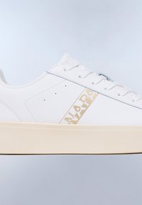 White leather sneaker with a textured surface, featuring a beige accent on the side displaying the brand name and flat white laces.
