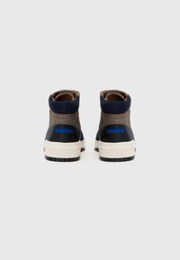 High-top sneakers with a combination of gray, blue, and black materials; featuring a textured finish, cream sole, and padded collar.