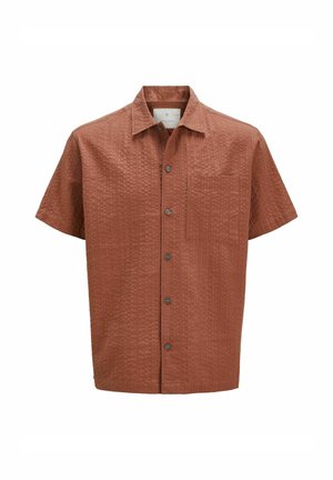 Kurzarmhemd in rostfarbener Farbe mit strukturiertem Muster. Besitzt einen spitzen Kragen, eine Knopfleiste und eine Brusttasche.