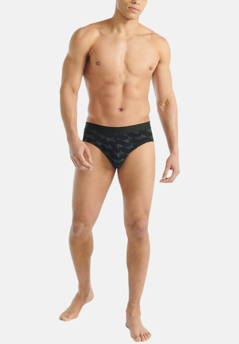 Musta miesten alushousut, joissa on kuviolyönti ja hienovaraisia geometrisiä kuvioita tummissa sävyissä. Valmistettu sileästä, joustavasta kankaasta mukavuutta varten.