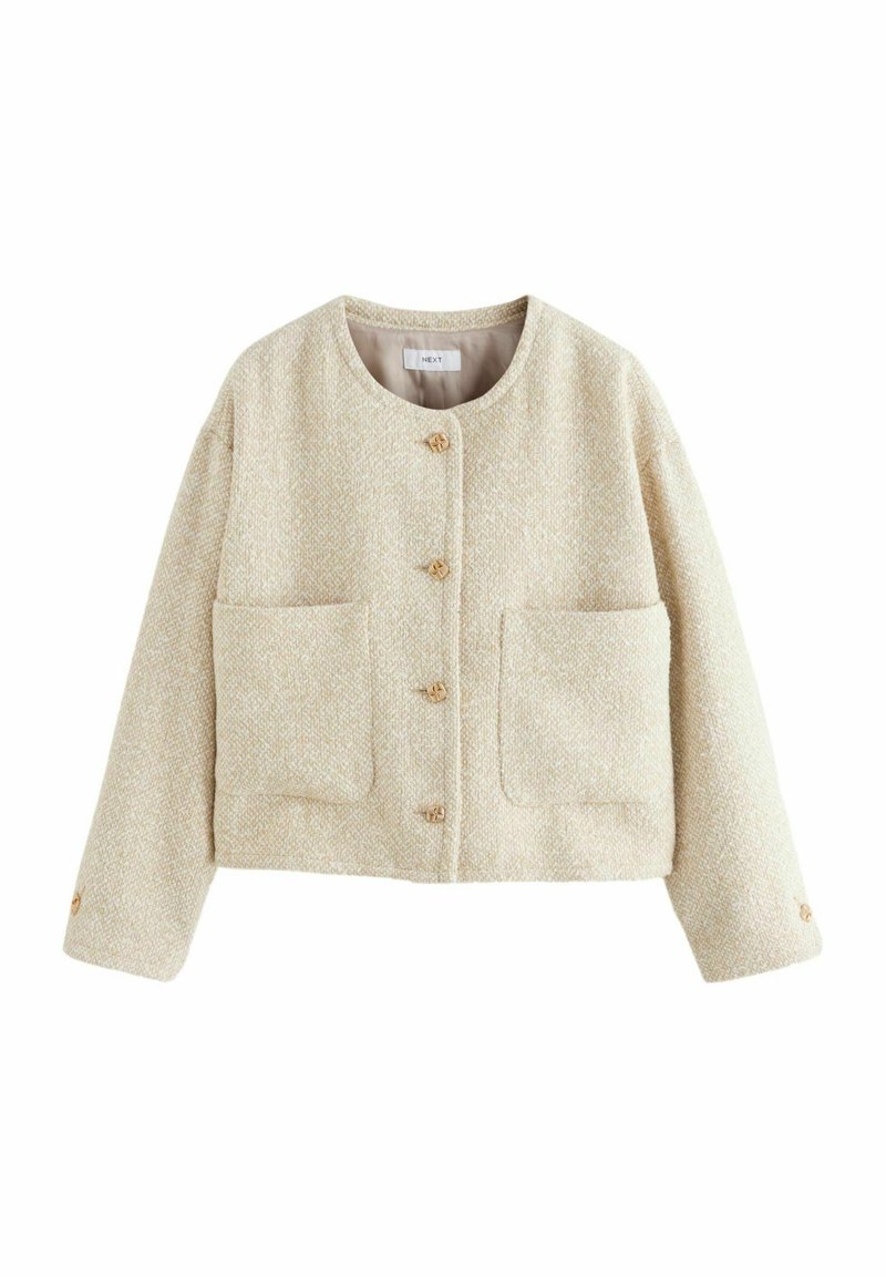 Cream-colored cropped jacket made of textured fabric, featuring a round neckline, four front buttons, and two large pockets.