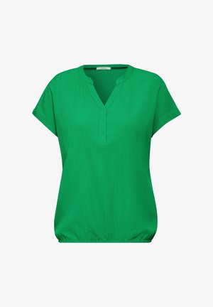 Blouse verte à manches courtes avec un col en V, en tissu texturé, et une légère fronce à la taille pour un ajustement décontracté.
