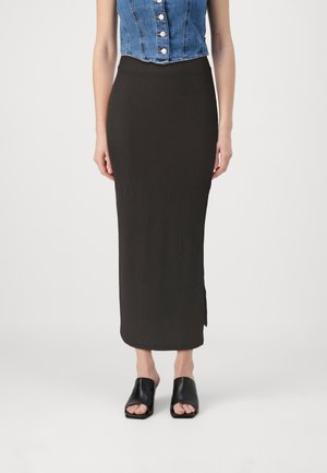 Black ribbed midi skirt with a fitted silhouette and side slit, paired with open-toe black slides. Denim top features button detailing.