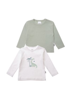 Two long-sleeve baby shirts, one light green plain and one white with a green dinosaur and palm tree print.