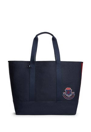 Tumesinine kandekott kahe õlarihmaga ja alumisel paremal esiküljel punase, valge ja sinise Tommy Hilfigeri embleemiga.