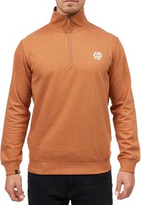 Orange, tekstureret fleece pullover med halv lynlås krave og logo på brystet. Har lange ærmer samt ribbede manchetter og kant.