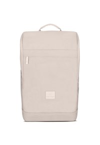 Beige backpack with a minimalist design, made of durable fabric. Features a top handle and a front zippered pocket, smooth texture.