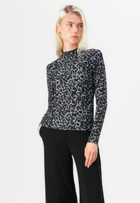 Long-sleeve top in stretchy, lightweight fabric featuring a black and gray leopard print, with a high neckline and fitted design.