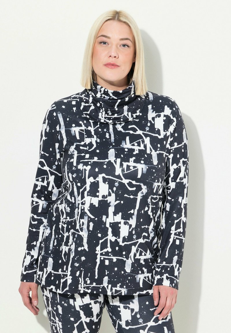 Tunic a motivo bianco e nero con collo a cowl, caratterizzata da design astratti di spruzzi e maniche lunghe, realizzata in un tessuto morbido e elasticizzato.