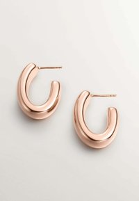 Pendientes de aro en oro rosa con un diseño curvado y suave. Acabado pulido con cierre de bisagra. Estilo minimalista y contemporáneo.