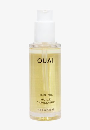 Flacon pompe en plastique transparent étiqueté "OUAI Hair Oil" contenant 45 ml d'huile capillaire jaune pâle sur un fond blanc.