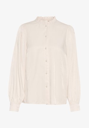 Világoskrémszínű blúz magas fodros gallérral, hosszú puffos ujjal és gyöngyszerű gombokkal ellátott gombos elülső résszel. Simaságával, selyemhez hasonló textúrájával tűnik ki.