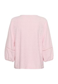 Top di cotone rosa chiaro con scollo rotondo, maniche a palloncino 3/4 e motivo ad occhiello su tutta la superficie. Orlo dritto senza ulteriori abbellimenti.