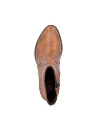 Bottines en cuir tan avec un bout arrondi, des coutures décoratives et une fermeture éclair sur le côté. Doublure intérieure douce visible.