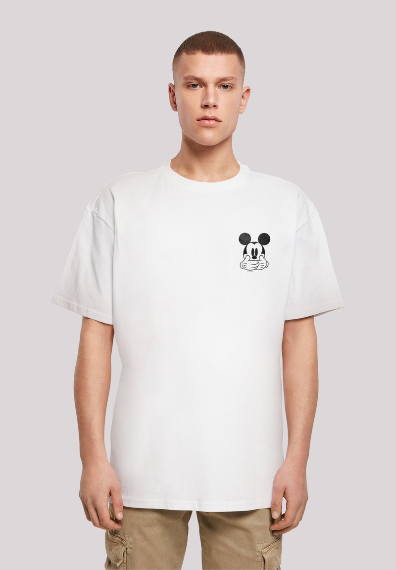 Hvid bomulds t-shirt med en sort grafisk af en tegneseriefigur på venstre bryst. Korte ærmer og rund halsudskæring.