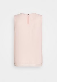 Blusa sin mangas de color rosa claro con escote redondo, abertura en la espalda con forma de ojo de cerradura y textura suave, que cae hasta la altura de la cadera.