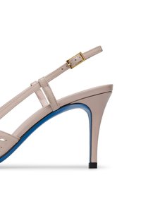 Beige high-heeled sandal with adjustable strap, featuring a blue accent on the sole, pointed toe, and thin stiletto heel.