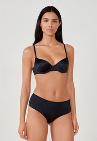 Black satin bra with underwire and adjustable straps, paired with high-waisted black satin panties. Smooth texture, minimalistic design.