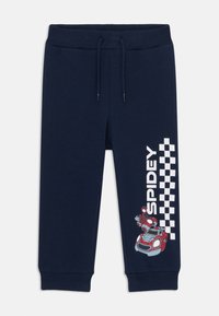 Pantalons de survêtement bleu marine avec un cordon de serrage à la taille, présentant un graphique "Spidey" et un motif à damier blanc, en tissu coton, avec des poignets côtelés.