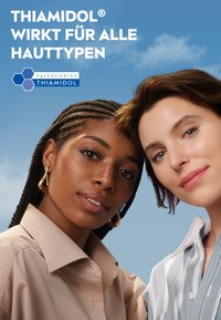 Two women, one with braided hair wearing a beige shirt, the other with short hair in a striped blue shirt, against a light blue background.