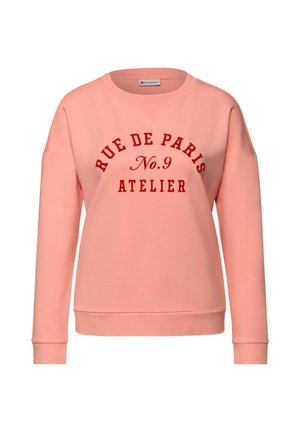 Różowa bluza z okrągłym dekoltem, o luźnym kroju, z czerwonym nadrukiem "RUE DE PARIS No.9 ATELIER." Miękki materiał.