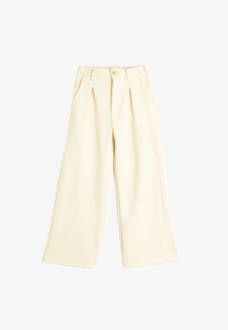 Cream-colored wide-leg trousers with a textured fabric, featuring front pleats and a gold heart-shaped button at the waistband.