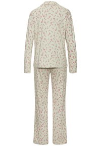 Langärmiges cremefarbenes Pyjama-Set mit rot-weißem Zuckerstangenmuster, bestehend aus einem Oberteil mit Kragen und einer Hose mit geradem Bein, von hinten gezeigt.