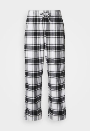 Pantalonas de pijama xadrez em preto e branco com cintura de cordão, textura macia, ajuste solto e padrão quadriculado por toda a peça.