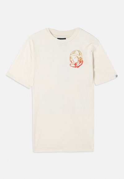 Kremowy bawełniany t-shirt z krótkimi rękawami i luźnym krojem, z kolorową grafiką astronauty na lewej piersi.