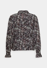 Blouse à manches longues avec motif floral abstrait en noir, blanc et rouge, poignets boutonnés et col à revers, vue de dos.