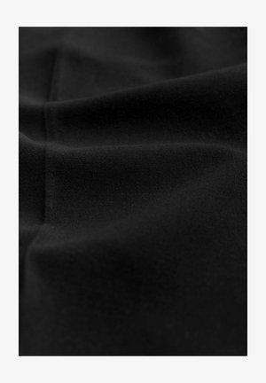 Black fabric with a smooth texture, featuring subtle folds and a matte finish. The material appears lightweight and flexible.