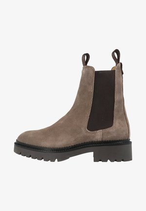 Brown suede Chelsea boot with elastic side panels, loop pull tabs, rugged rubber sole, and stitched detailing along the upper edge.