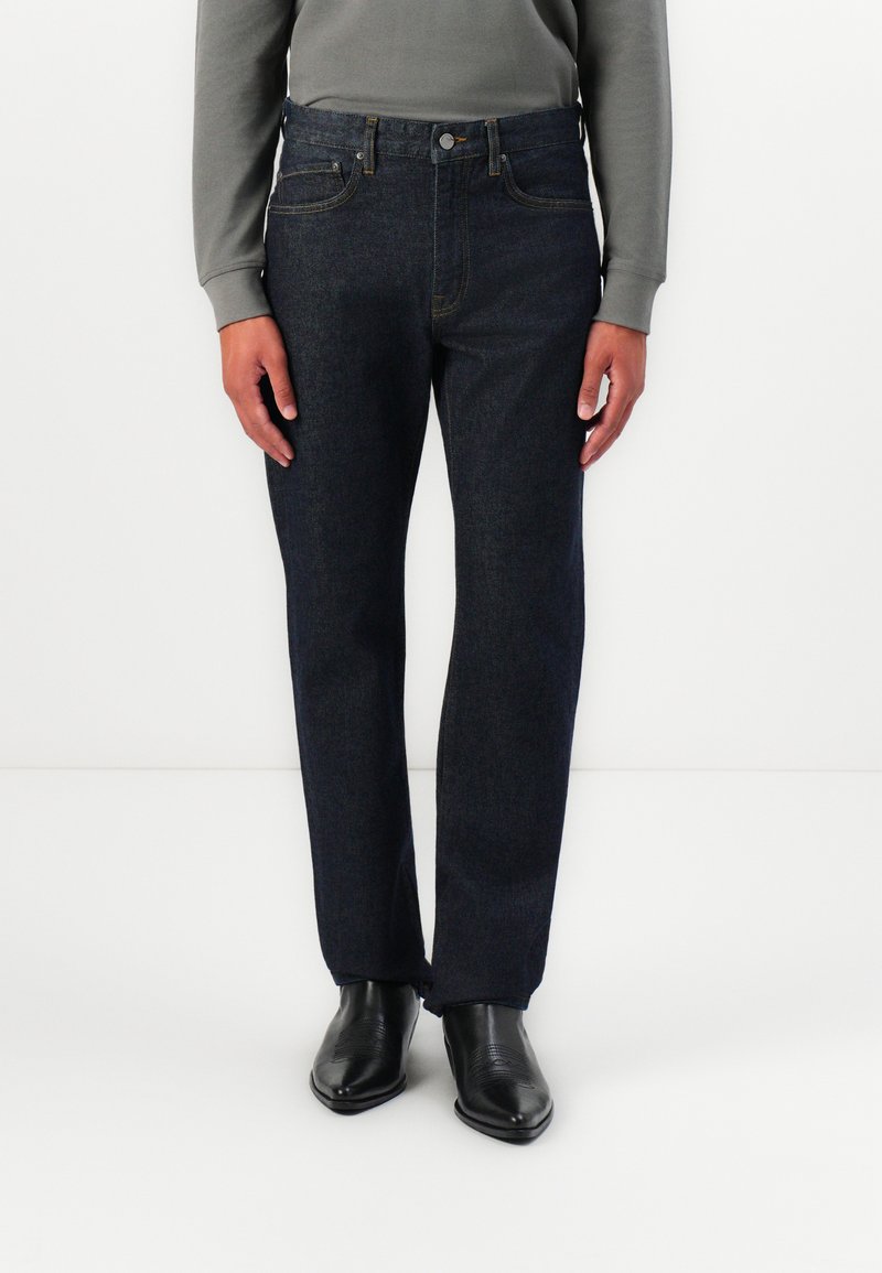 Dark blue denim jeans with a straight leg design, featuring five pockets, belt loops, and a classic button closure. Texture is smooth.