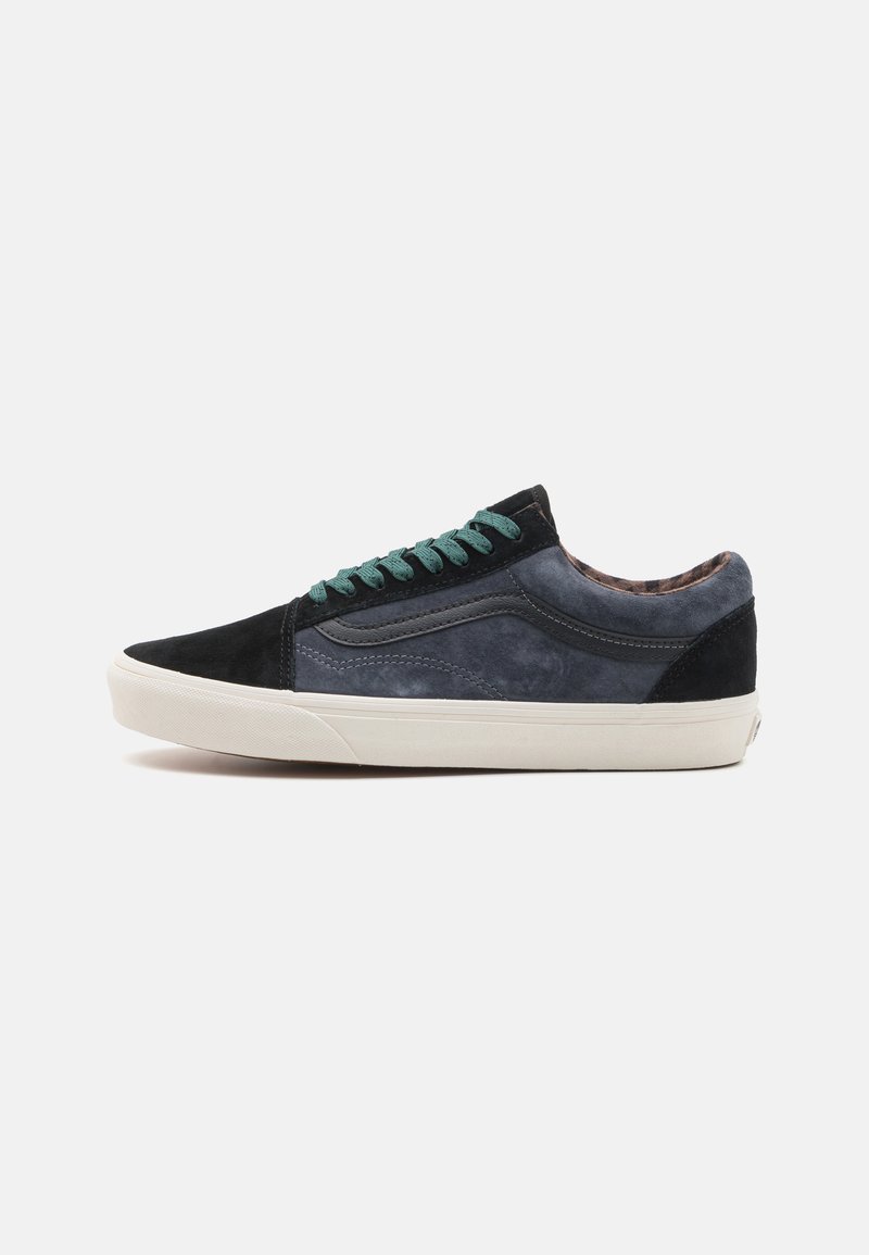 Black and navy blue suede sneakers with textured sections, green laces, and a white rubber sole; low-top design with minimal branding.