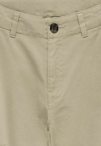 Beige cotton pants with a flat front, button closure, and belt loops. Features subtle stitching details and classic pocket design.