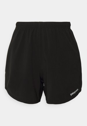 Shorts de sport noirs avec une taille élastique, présentant un ourlet arrondi, des poches latérales et un petit logo "Patagonia" blanc en bas à droite.