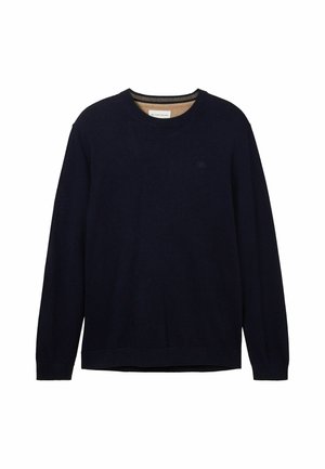 Tummansininen neule, joka on valmistettu pehmeästä materiaalista. Siinä on pyöreä kaula-aukko, pitkät hihat ja huomaamaton logo rinnassa. Sujuva pinta ja rento istuvuus.