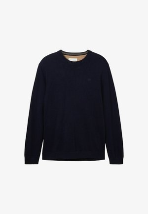 Tummansininen neule, joka on valmistettu pehmeästä materiaalista. Siinä on pyöreä kaula-aukko, pitkät hihat ja huomaamaton logo rinnassa. Sujuva pinta ja rento istuvuus.