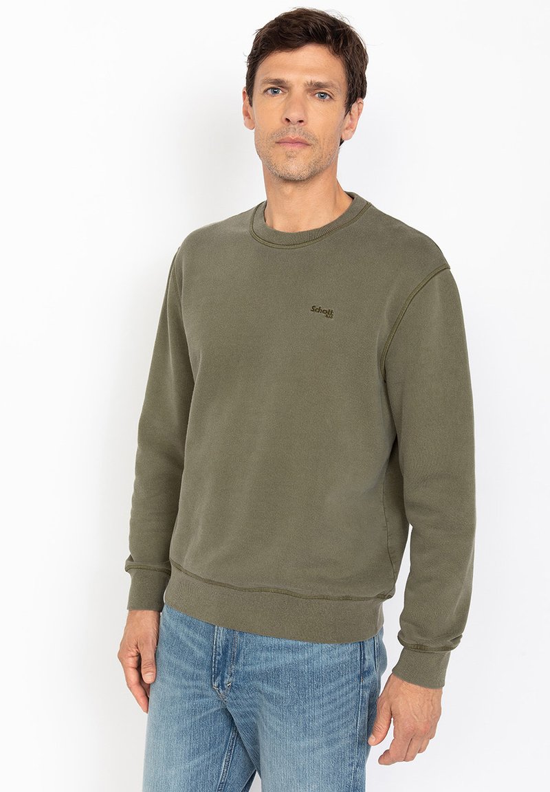 Olijfgroene crewneck sweatshirt van zachte stof, met ribbelmanchetten en -zoom, een klein logo op de borst en een ontspannen pasvorm.
