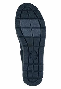 Black rubber shoe sole with a textured surface, featuring a pattern of rectangular tread lines for grip and a circular logo imprint.